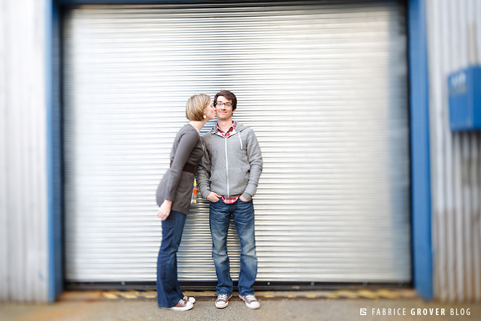 Couple kiss in front of loading bay on Granville Island BC engagement photographer shoot